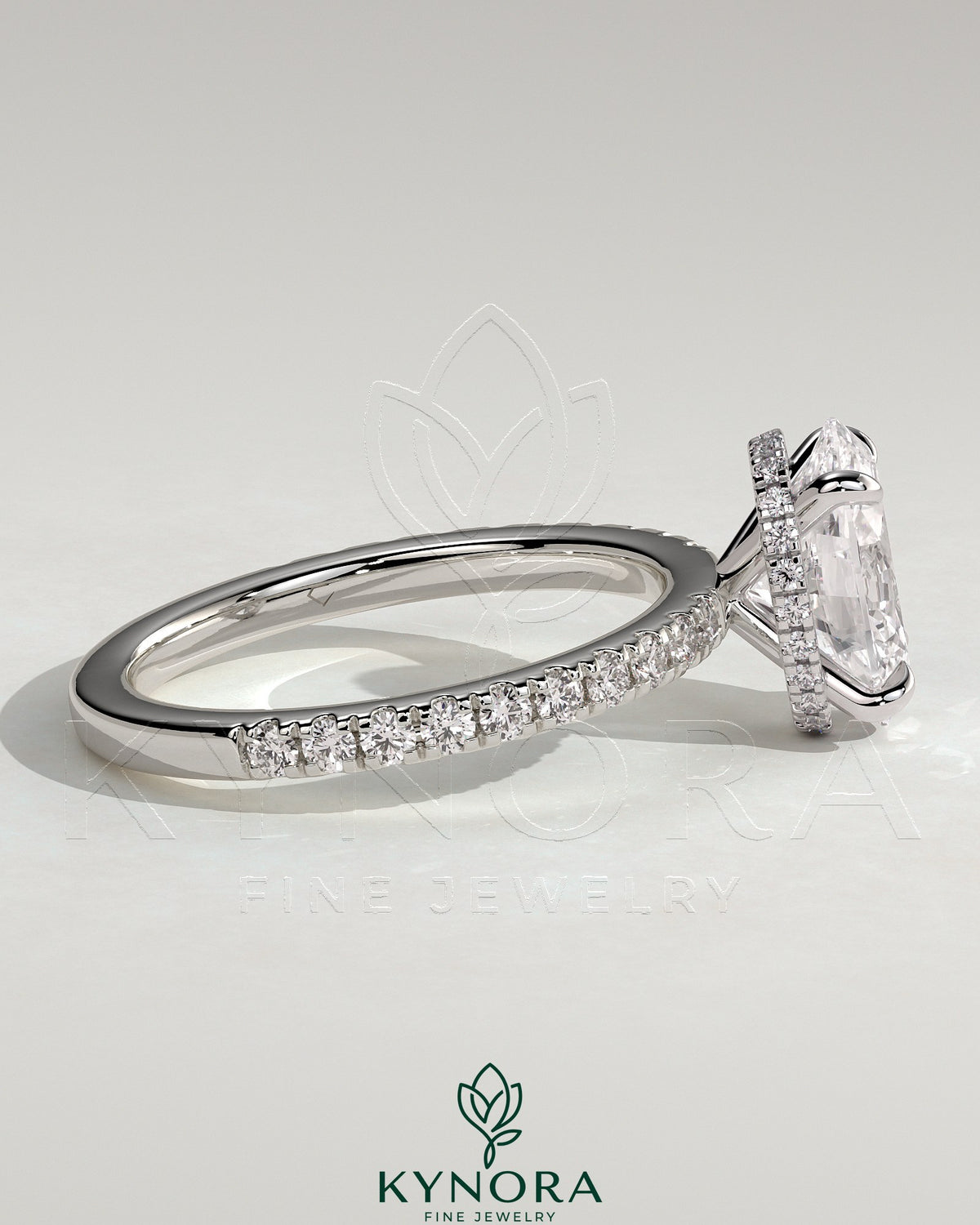 Kynora CJ 2ct oval claw solitaire engagement ring with hidden halo and pave band, showcasing elegant diamond setting and craftsmanship.