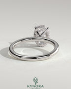Kynora CJ 2ct oval claw solitaire engagement ring with wrap-around hidden halo in sterling silver or gold.