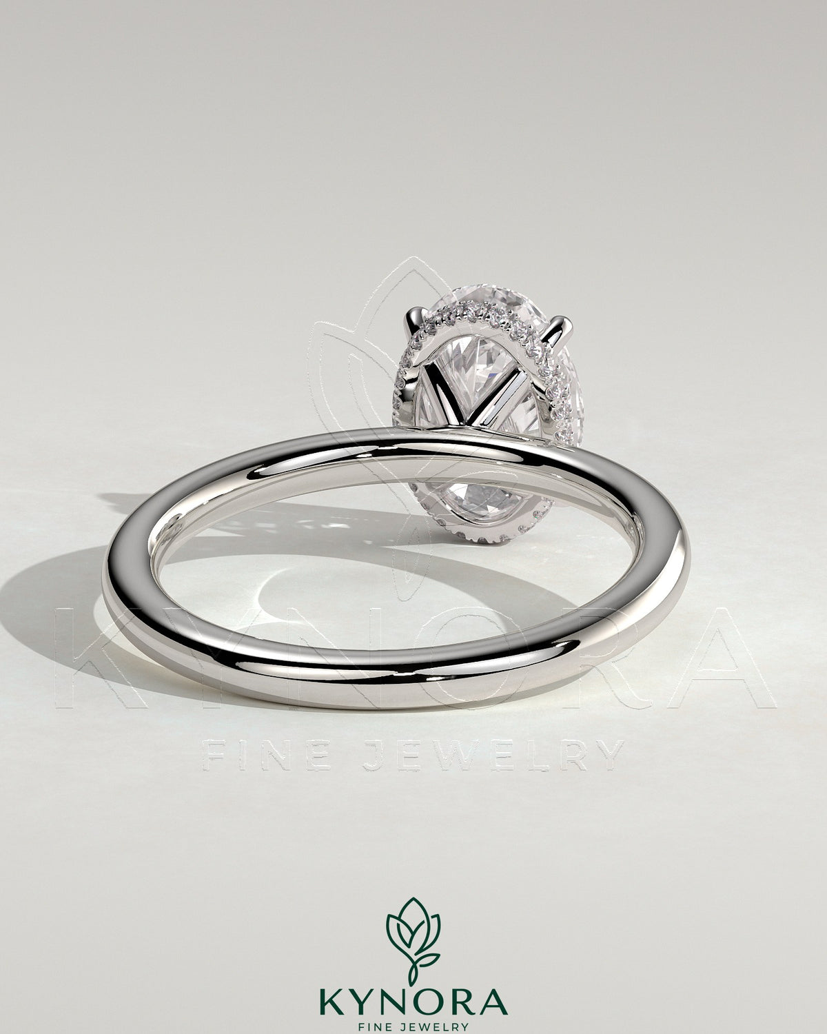 Kynora CJ 2ct oval claw solitaire engagement ring with wrap-around hidden halo in sterling silver or gold.
