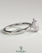 Kynora CJ 2ct oval claw solitaire engagement ring with a wrap-around hidden halo in silver with a gemstone setting.