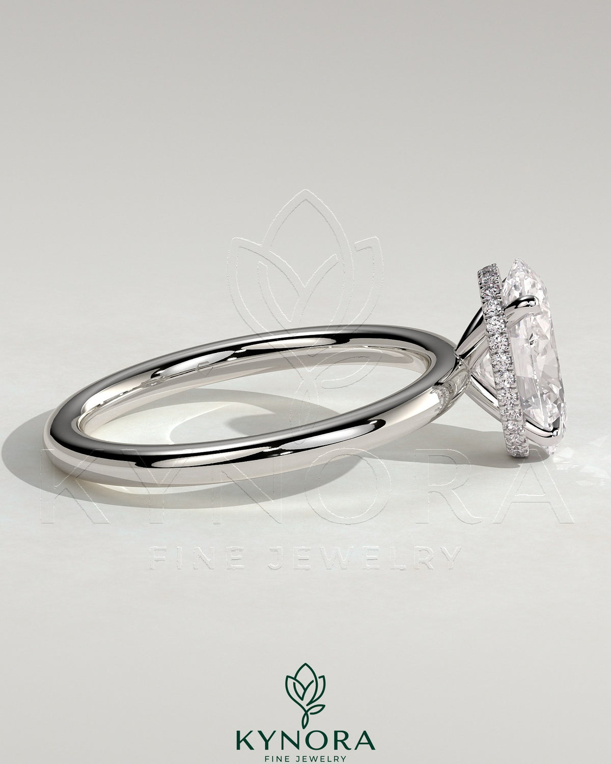 Kynora CJ 2ct oval claw solitaire engagement ring with a wrap-around hidden halo in silver with a gemstone setting.