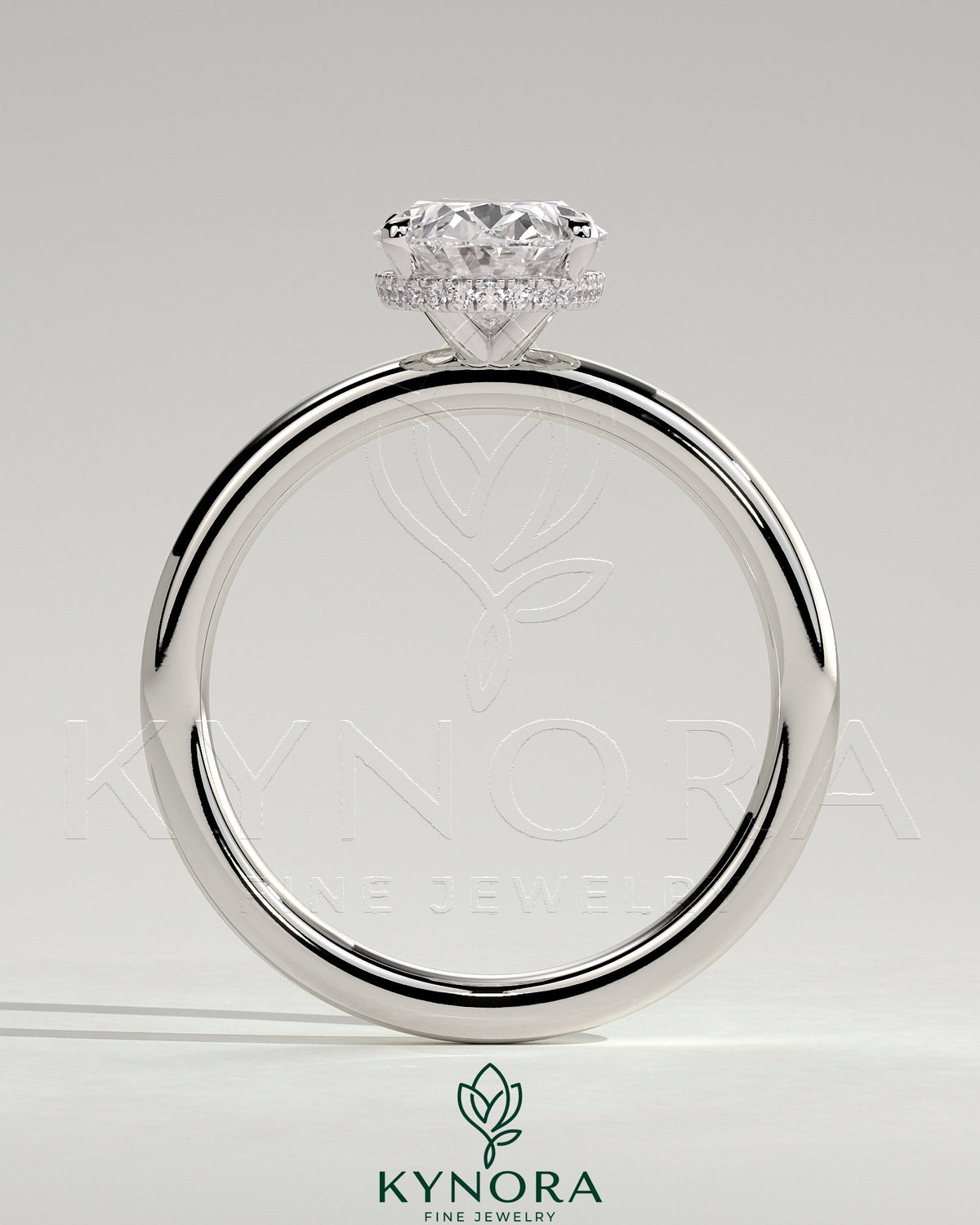 Kynora CJ 2ct oval claw solitaire engagement ring with a wrap-around hidden halo, showcasing elegant diamond setting.