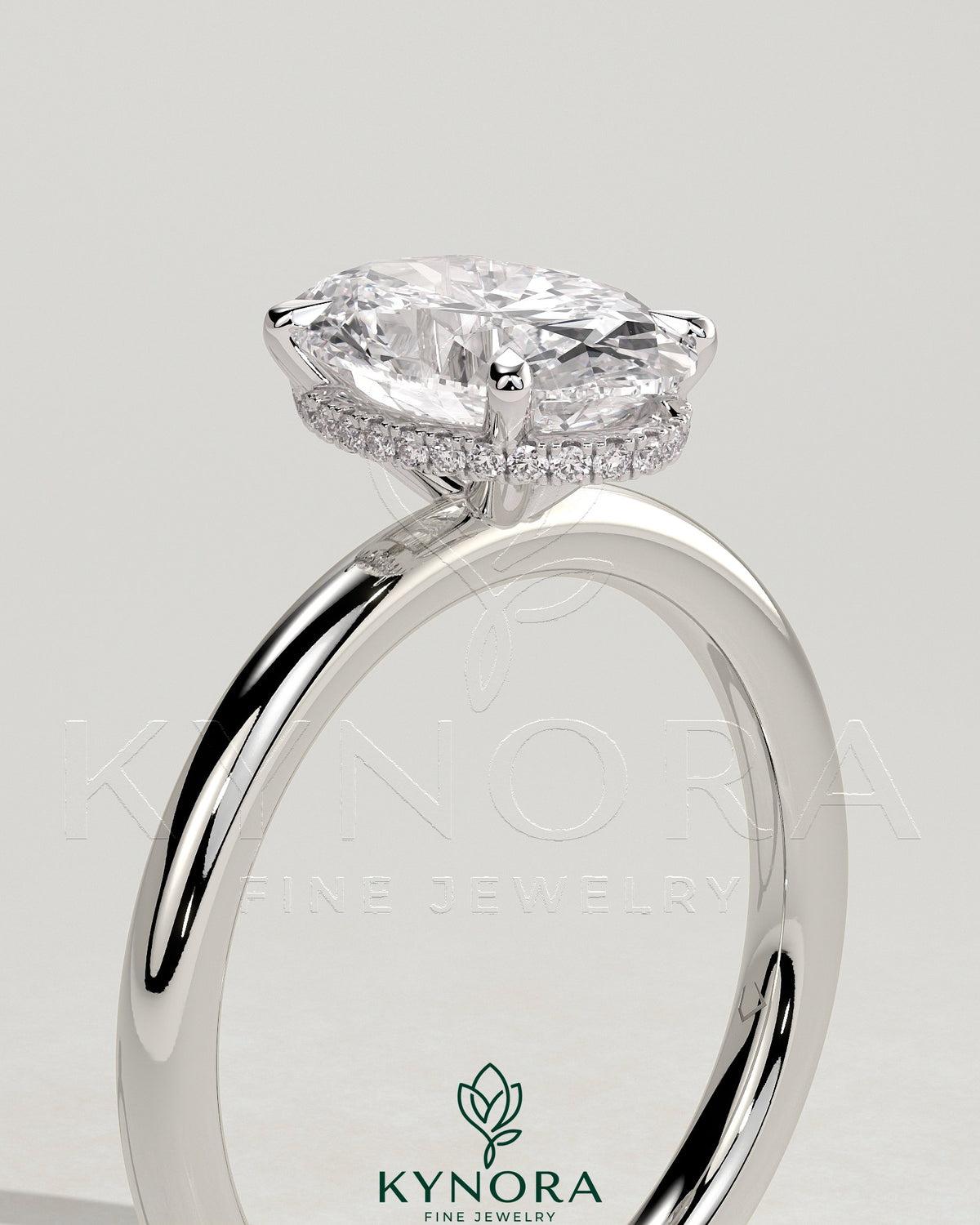 Kynora CJ 2ct oval claw solitaire engagement ring with a wrap-around hidden halo, showcasing a sparkling center stone and intricate design.