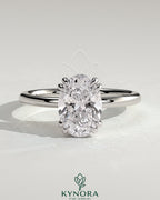 Kynora CJ 2ct oval double claw solitaire engagement ring with hidden halo, showcasing elegant diamond setting and sparkling design.