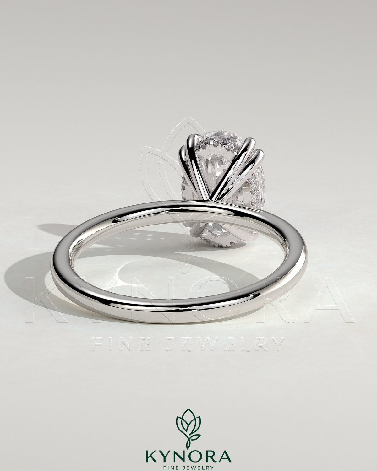 Kynora CJ 2ct oval double claw solitaire engagement ring with hidden halo, showcasing a sparkling oval diamond and elegant band.