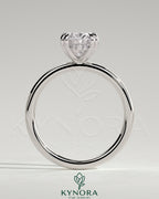 Kynora CJ 2ct oval double claw solitaire engagement ring with hidden halo, featuring a sparkling diamond setting.