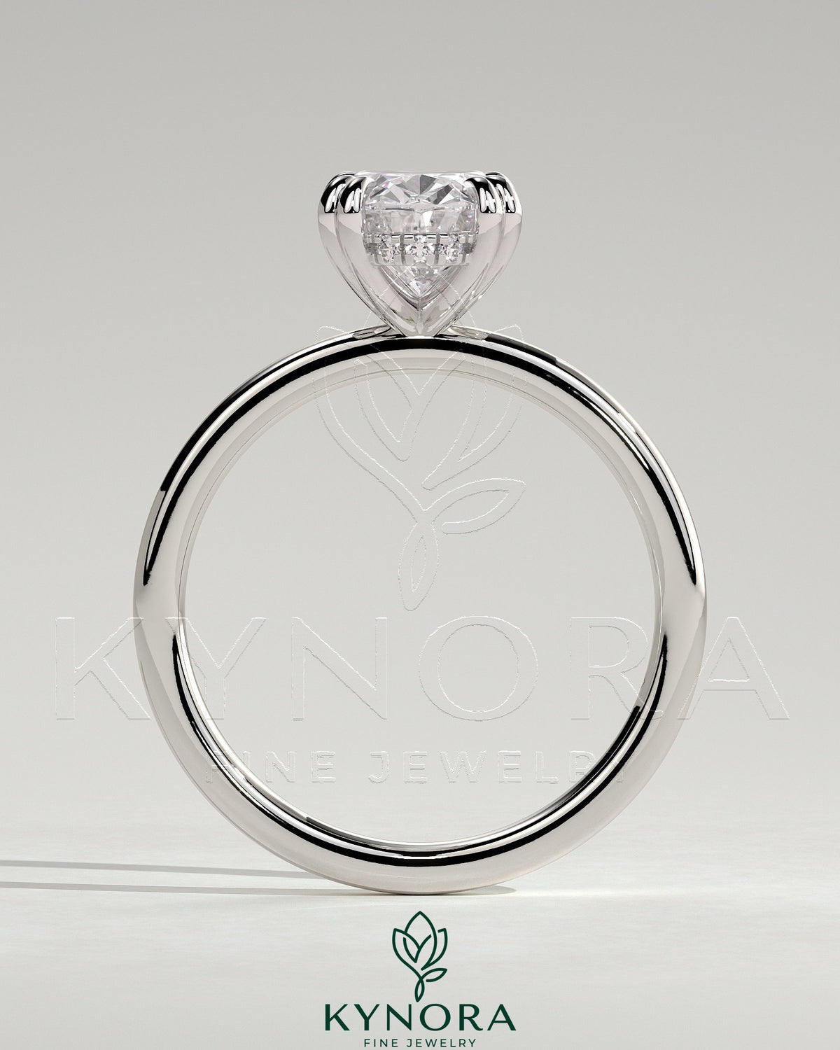 Kynora CJ 2ct oval double claw solitaire engagement ring with hidden halo, featuring a sparkling diamond setting.