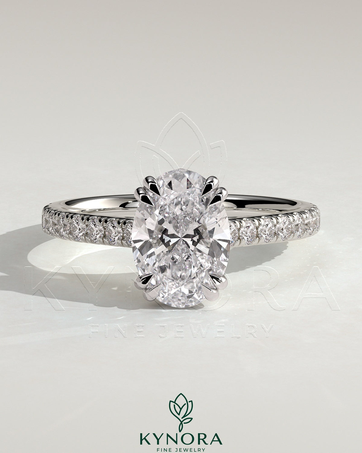 Kynora CJ 2ct oval double claw solitaire engagement ring with hidden halo, pave band, and cathedral high setting, showcasing intricate design. Main image