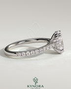 Kynora CJ 2ct oval double claw solitaire engagement ring with hidden halo, pave band, and cathedral high setting.