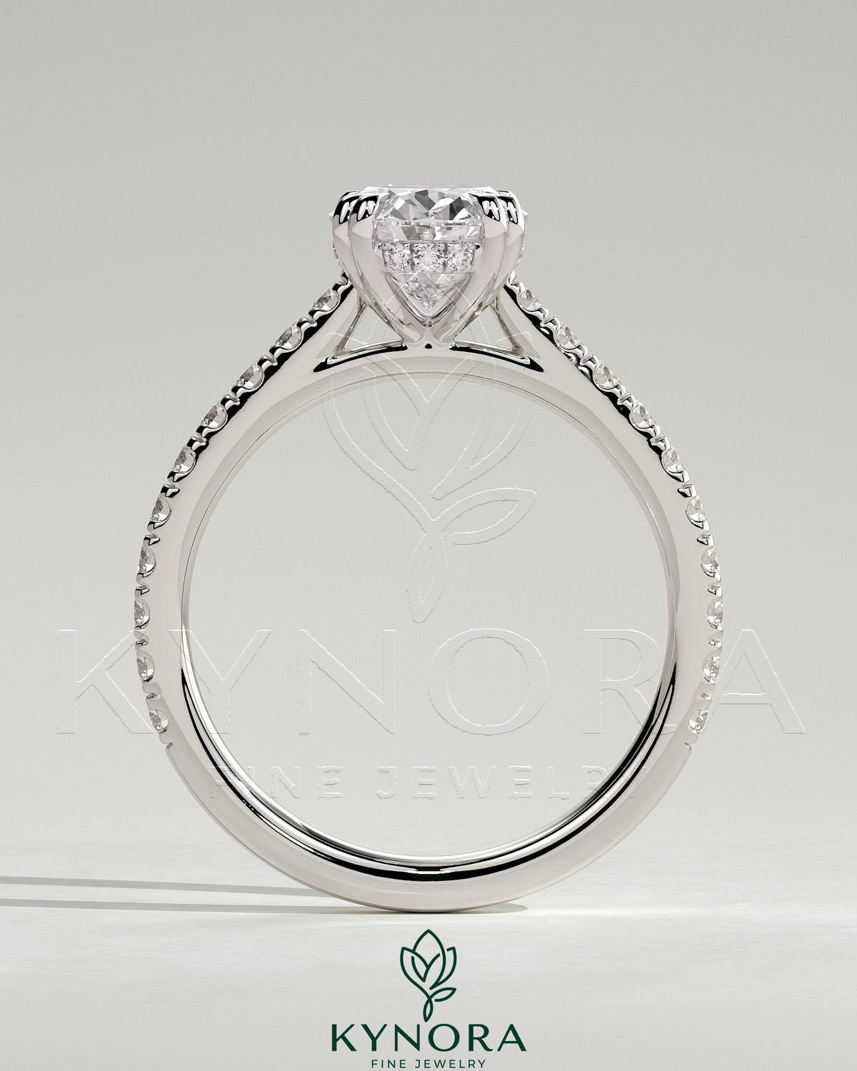 Kynora CJ 2ct oval double claw solitaire engagement ring with hidden halo, pave band, and cathedral high setting.