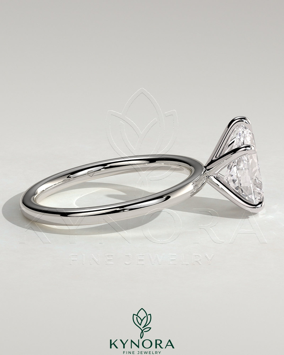 Kynora CJ 2-carat pear-shaped diamond solitaire engagement ring with five-prong setting on a sleek band.