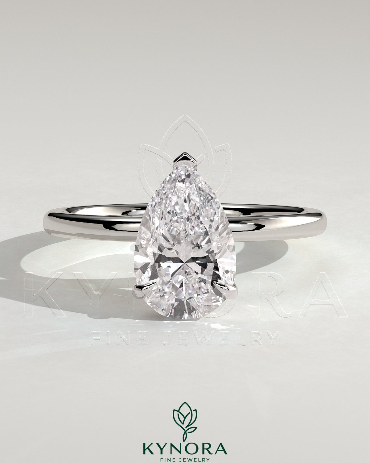 Kynora CJ 2-carat pear-shaped diamond solitaire engagement ring with three prongs on a sleek gold band.