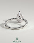 Kynora CJ 2ct pear-shaped diamond solitaire engagement ring with three prong setting on a sleek band.