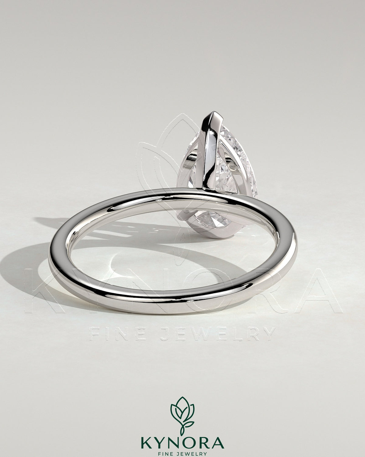 Kynora CJ 2ct pear-shaped diamond solitaire engagement ring with three prong setting on a sleek band.