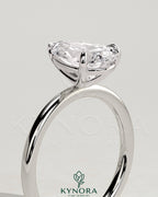 Kynora CJ 2ct pear-shaped diamond solitaire engagement ring with three-prong setting showcasing the elegant gemstone.