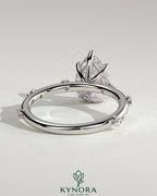 Kynora CJ 2ct pear-shaped diamond solitaire engagement ring with six accent stones and a hidden halo design.