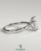 Kynora CJ 2ct pear-shaped solitaire engagement ring with six accent stones and hidden halo, featuring elegant jewelry design.