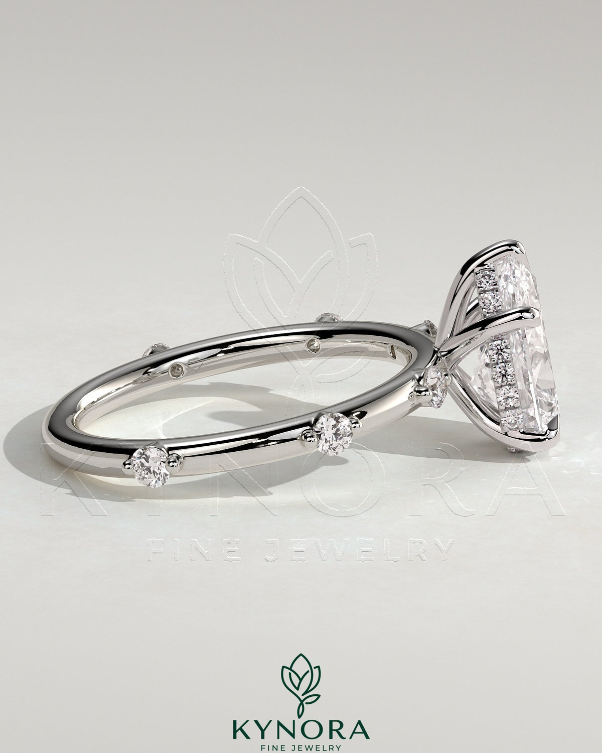Kynora CJ 2ct pear-shaped solitaire engagement ring with six accent stones and hidden halo, featuring elegant jewelry design.
