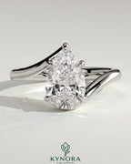 Kynora CJ 2ct pear-shaped diamond solitaire engagement ring with bypass band in sleek gold setting.