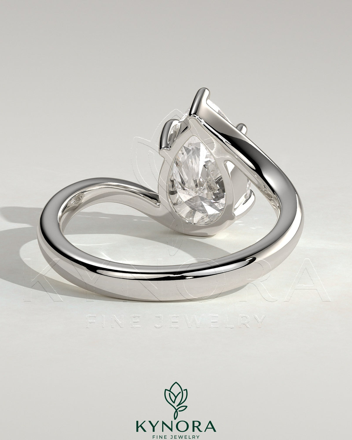 Kynora CJ 2ct pear-shaped diamond solitaire engagement ring with bypass band in elegant gold setting.