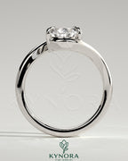 Kynora CJ 2ct pear-shaped diamond solitaire engagement ring with bypass band in silver finish, showcasing elegant design.