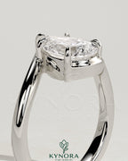 Kynora CJ 2ct pear-shaped diamond solitaire engagement ring with bypass band in platinum setting.