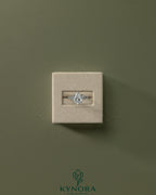 Kynora CJ 2ct pear-shaped diamond solitaire engagement ring with clustered round shoulder stones in a sleek platinum setting.