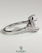 Kynora CJ 2ct pear-shaped diamond solitaire engagement ring with clustered round shoulder stones in a sleek platinum setting