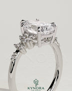 Kynora CJ 2ct pear-shaped diamond solitaire engagement ring with cluster round shoulder stones in elegant jewelry setting