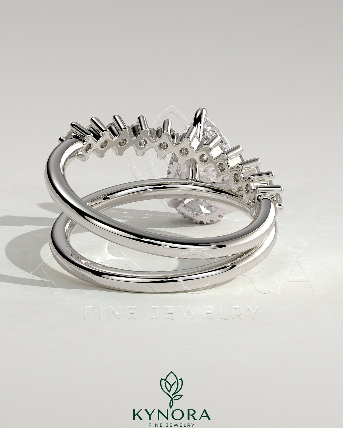 Kynora CJ 2ct pear-shaped diamond solitaire engagement ring with double plain and round accent stones on band.