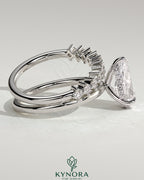 Kynora CJ 2ct pear-shaped diamond solitaire engagement ring with double plain and round accent stones band.