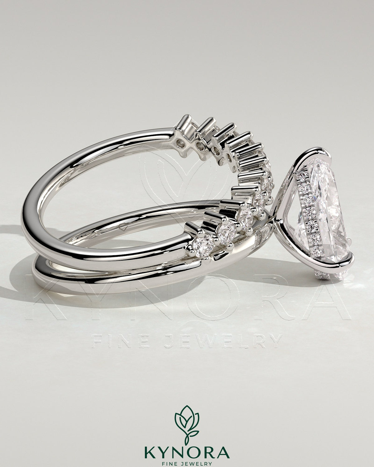 Kynora CJ 2ct pear-shaped diamond solitaire engagement ring with double plain and round accent stones band.