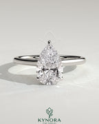 Kynora CJ 2ct pear-shaped moissanite solitaire engagement ring with hidden halo and cathedral high setting in sterling silver.