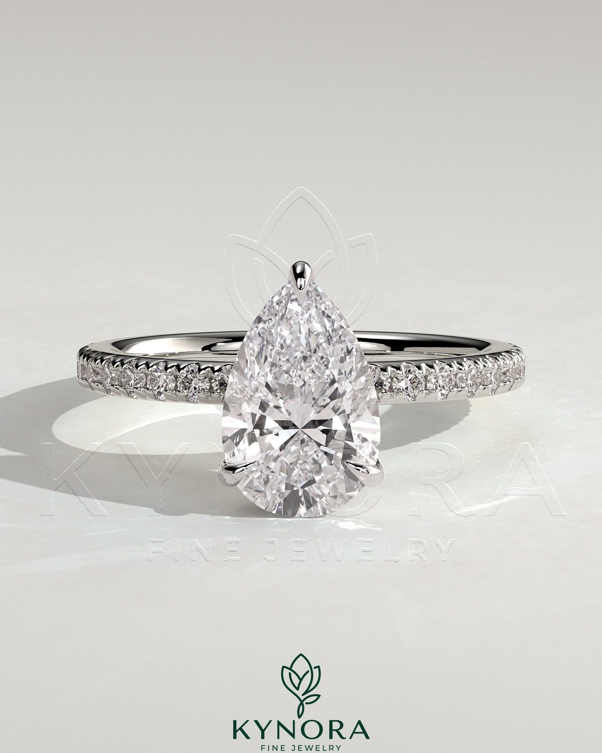 Kynora CJ 2ct pear-shaped diamond solitaire engagement ring with hidden halo and pave band, elegant jewelry piece.