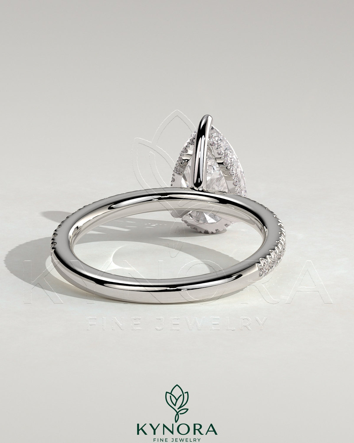 Kynora CJ 2ct pear-shaped diamond solitaire engagement ring with hidden halo and pave band, elegant and sparkling jewelry piece.