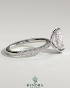 Kynora CJ 2ct pear-shaped diamond solitaire engagement ring with hidden halo and pave band, crafted in elegant jewelry design.