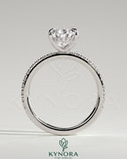 Kynora CJ 2ct pear-shaped solitaire engagement ring with hidden halo and pave band, showcasing elegant jewelry design.