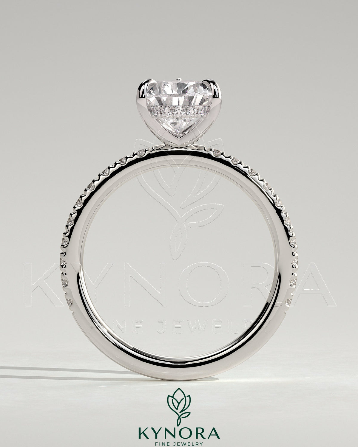 Kynora CJ 2ct pear-shaped solitaire engagement ring with hidden halo and pave band, showcasing elegant jewelry design.