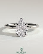 Kynora CJ 2ct pear-shaped diamond solitaire engagement ring with hidden halo setting, featuring a sleek gold band.