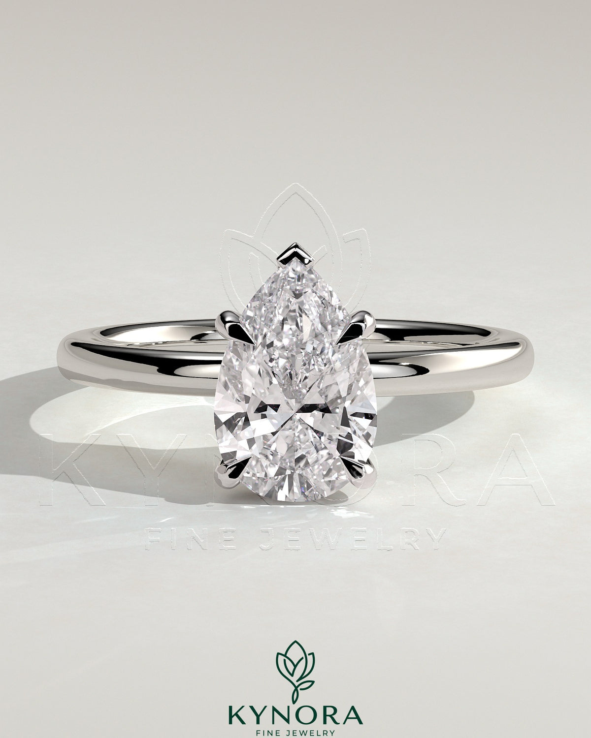 Kynora CJ 2ct pear-shaped diamond solitaire engagement ring with hidden halo setting, featuring a sleek gold band.