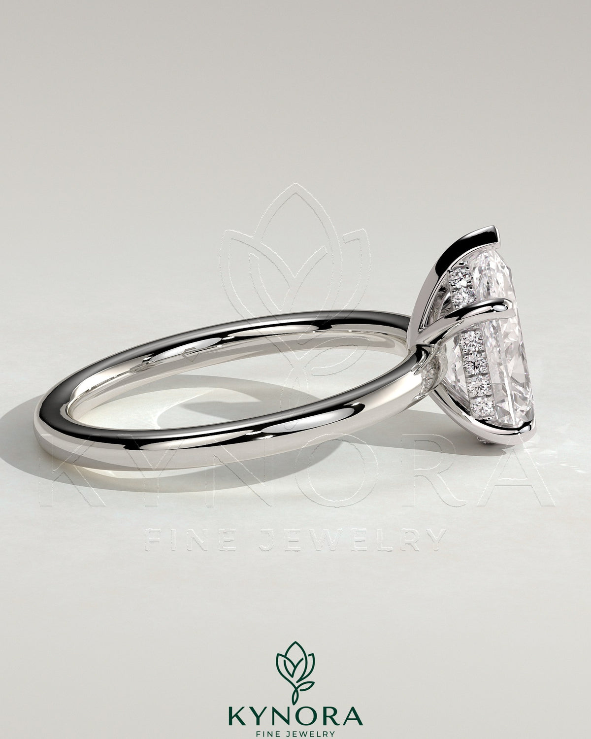 Kynora CJ 2ct pear-shaped diamond solitaire engagement ring with hidden halo setting, elegant and sparkling jewelry piece.
