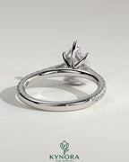 Kynora CJ 2ct pear-shaped diamond solitaire engagement ring with hidden halo, pave band, and cathedral high setting.