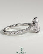 Kynora CJ 2ct pear-shaped diamond solitaire engagement ring with hidden halo, pave band, and cathedral high setting.