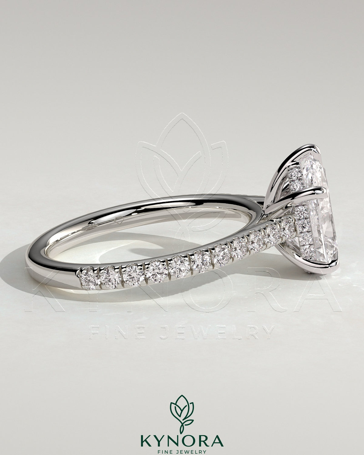 Kynora CJ 2ct pear-shaped diamond solitaire engagement ring with hidden halo, pave band, and cathedral high setting.