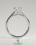 Kynora CJ 2ct pear-shaped diamond solitaire engagement ring with hidden halo, pave band, and cathedral high setting.