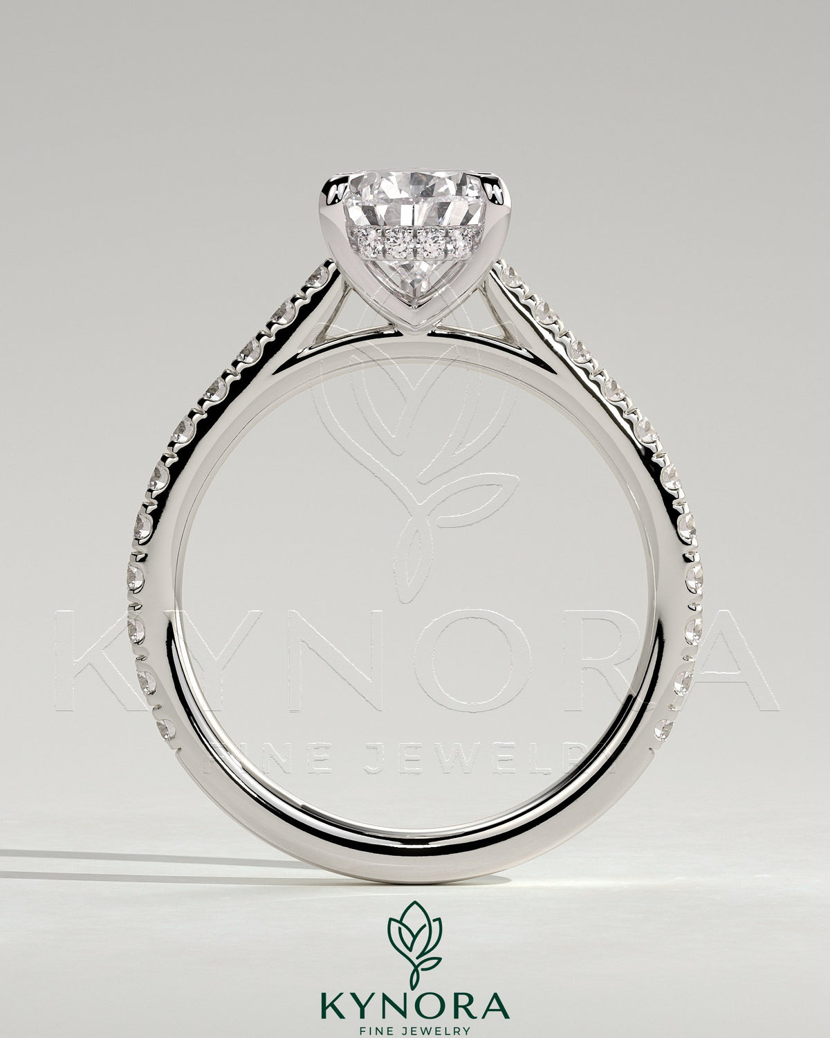Kynora CJ 2ct pear-shaped diamond solitaire engagement ring with hidden halo, pave band, and cathedral high setting.