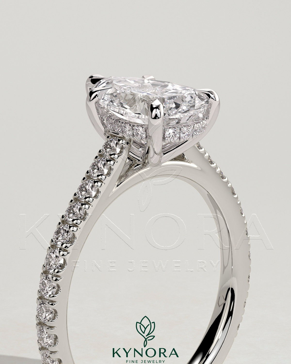 Kynora CJ 2ct pear-shaped diamond solitaire engagement ring with hidden halo, pave band, and cathedral high setting.