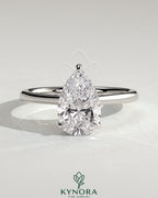 Kynora CJ 2ct pear-shaped diamond solitaire engagement ring with hidden halo, tapered band, and cathedral high setting.