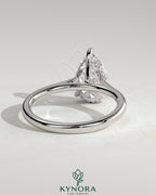 Kynora CJ 2ct pear-shaped diamond solitaire engagement ring with hidden halo, tapered band, and cathedral high setting.