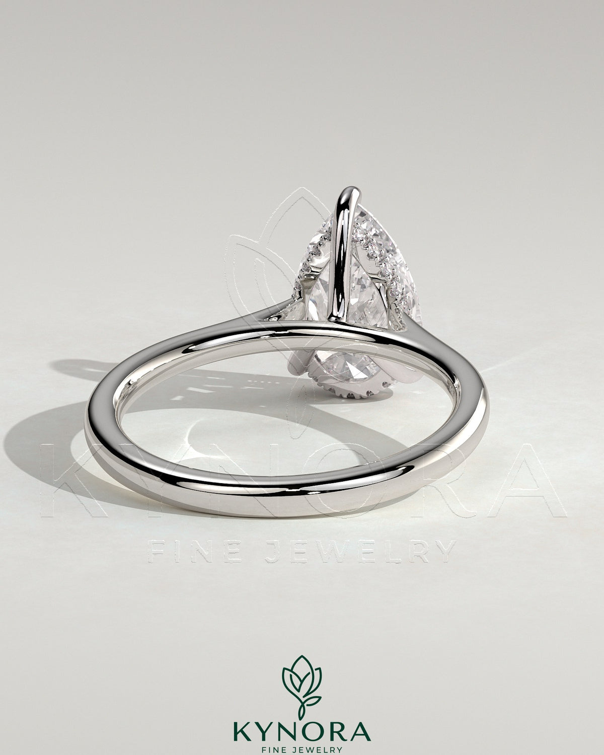 Kynora CJ 2ct pear-shaped diamond solitaire engagement ring with hidden halo, tapered band, and cathedral high setting.